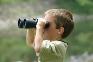 boy looking through binoculars